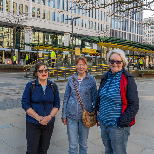 A picture of Carol, Kate and Sheila stood in central Manchester in front of a tram station