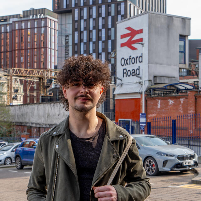 A picture of Joe Leath stood outside Oxford Road train station in central Manchester, UK