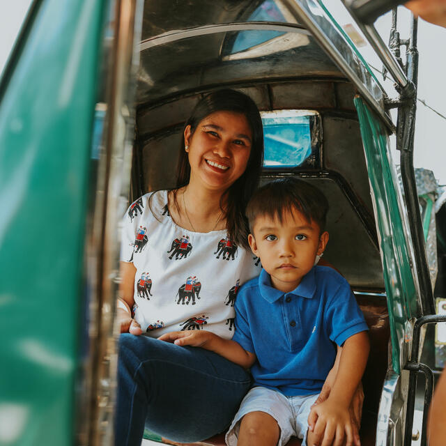 A picture of Cora Mostrales and their son in a transport vehicle 